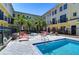 Community pool area featuring lounge chairs, tropical landscaping, and easy access to townhome living at 133 S Sherrill St # 133, Tampa, FL 33609