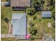 Aerial view showcases the home's new metal roof, lush landscaping, and fenced yard at 1740 Grove Dr, Clearwater, FL 33759