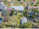 Aerial view features the home, fenced yard, landscaping, and storage shed at 1740 Grove Dr, Clearwater, FL 33759