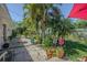 The backyard patio offers lush tropical landscaping and a charming garden at 1740 Grove Dr, Clearwater, FL 33759