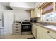 Functional kitchen features stainless steel oven, and natural light from a window with a view at 1740 Grove Dr, Clearwater, FL 33759