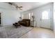 Comfortable living room features a ceiling fan, neutral walls, and a plush brown sofa at 1740 Grove Dr, Clearwater, FL 33759