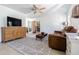 Bright living room featuring wood-look ceiling fan, comfortable sofa, and a decorative rug at 1740 Grove Dr, Clearwater, FL 33759