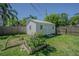 Fenced backyard with a storage shed and landscaping at 1740 Grove Dr, Clearwater, FL 33759