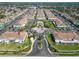 A high angle aerial view shows many condos and landscaping with an arrow indicating a unit's location at 1811 Fluorshire Dr, Brandon, FL 33511