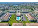 An aerial view of the community showcasing the pool, landscaping, and residential buildings near a lake at 1811 Fluorshire Dr, Brandon, FL 33511
