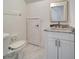 White bathroom with marble countertop vanity and a toilet at 1811 Fluorshire Dr, Brandon, FL 33511