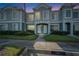 Evening shot of a well-maintained two-story townhome exterior showcases manicured landscaping and entrances at 1811 Fluorshire Dr, Brandon, FL 33511