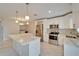 Open kitchen featuring an island, stainless steel appliances, marble countertops and flooring at 1811 Fluorshire Dr, Brandon, FL 33511