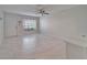 Open-concept living space with tile floors, fan, and a bright window view at 1811 Fluorshire Dr, Brandon, FL 33511