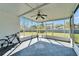 Enclosed patio offers protection from bugs, ceiling fan, and view to the backyard at 1811 Fluorshire Dr, Brandon, FL 33511