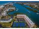 An aerial view of the coastal community with tennis courts, lush landscaping, and waterfront access at 19451 Gulf Blvd # 301, Indian Shores, FL 33785