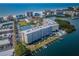 Panoramic aerial view of a condo building with waterfront access, private docks, tennis courts, and beach proximity at 19451 Gulf Blvd # 301, Indian Shores, FL 33785