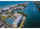 Aerial view of a coastal community featuring beachfront condos, a pool, and tennis courts at 19451 Gulf Blvd # 301, Indian Shores, FL 33785