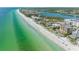 The beachfront community boasts a pristine beach with turquoise water and residential buildings at 19451 Gulf Blvd # 301, Indian Shores, FL 33785