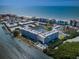 Expansive aerial shot highlights a condo complex with boat docks, a pool, tennis courts, and proximity to the beach at 19451 Gulf Blvd # 301, Indian Shores, FL 33785