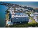 Breathtaking aerial perspective of condo community, showcasing waterfront views, private boat access, and tennis courts at 19451 Gulf Blvd # 301, Indian Shores, FL 33785