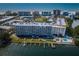 Stunning aerial view of beachfront condos featuring private boat docks and a refreshing community pool by the bay at 19451 Gulf Blvd # 301, Indian Shores, FL 33785