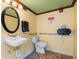 Bathroom featuring sink, toilet, handrails and 'Caution' sign at 19451 Gulf Blvd # 301, Indian Shores, FL 33785