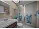 Clean bathroom featuring a sink, mirror, toilet, and shower at 19451 Gulf Blvd # 301, Indian Shores, FL 33785