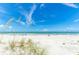 A picturesque beach scene with white sand, clear blue water, and sea oats swaying in the breeze at 19451 Gulf Blvd # 301, Indian Shores, FL 33785