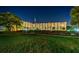 Exterior view of the condominium building with manicured lawns at 19451 Gulf Blvd # 301, Indian Shores, FL 33785