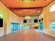 Open clubhouse area with wood floors and large windows overlooking the pool at 19451 Gulf Blvd # 301, Indian Shores, FL 33785