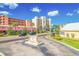 Street-level view of the community's sign near well-maintained grounds and residential buildings at 19451 Gulf Blvd # 301, Indian Shores, FL 33785