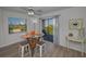 Dining area boasts modern table and chairs with a balcony overlooking lush greenery at 19451 Gulf Blvd # 301, Indian Shores, FL 33785