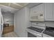 Cozy kitchen featuring a microwave and electric stove adjacent to hallway to living room at 19451 Gulf Blvd # 301, Indian Shores, FL 33785