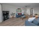 Open living room with ceiling fan, wood-look floors, comfortable seating and neutral paint at 19451 Gulf Blvd # 301, Indian Shores, FL 33785