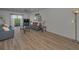 Airy living room featuring wood flooring, comfortable seating, and access to a private balcony at 19451 Gulf Blvd # 301, Indian Shores, FL 33785