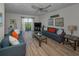Bright living room with ceiling fan, balcony, and water view at 19451 Gulf Blvd # 301, Indian Shores, FL 33785