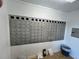 Wall of metal mailboxes with unit numbers in a tidy, well-maintained resident mail room at 19451 Gulf Blvd # 301, Indian Shores, FL 33785
