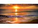 Scenic ocean view featuring a colorful sunset, gentle waves, and sandy beach at 19451 Gulf Blvd # 301, Indian Shores, FL 33785