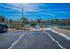 Image showcases designated parking spaces near well-maintained tennis courts and landscaped surroundings at 19451 Gulf Blvd # 301, Indian Shores, FL 33785