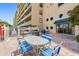 Lovely outdoor patio area with dining table, chairs, and BBQ grills at 19451 Gulf Blvd # 301, Indian Shores, FL 33785