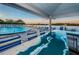 Community pool with lounge chairs and bar seating overlooking serene water views at 19451 Gulf Blvd # 301, Indian Shores, FL 33785