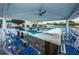 Outdoor pool bar featuring blue and white epoxy counter top and ceiling fan at 19451 Gulf Blvd # 301, Indian Shores, FL 33785
