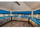Spacious outdoor pool bar with lots of seating and a ceiling fan for added comfort at 19451 Gulf Blvd # 301, Indian Shores, FL 33785