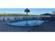Community pool on the water features an outdoor bar and lounge chairs at 19451 Gulf Blvd # 301, Indian Shores, FL 33785