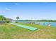 Beautiful waterfront recreational area with a shuffleboard court, dock, and river views at 19451 Gulf Blvd # 301, Indian Shores, FL 33785