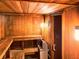 Relaxing, wood-paneled sauna featuring a bench and traditional heater at 19451 Gulf Blvd # 301, Indian Shores, FL 33785