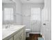 Well-lit bathroom with a single sink, storage vanity, and accessible grab bars at 2325 W Del Webb Blvd, Sun City Center, FL 33573