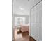 Bright bedroom features gleaming hardwood floors, a large window, and a spacious closet for ample storage at 2325 W Del Webb Blvd, Sun City Center, FL 33573