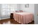 This bedroom features a bright window, gleaming hardwood floors, and lots of space at 2325 W Del Webb Blvd, Sun City Center, FL 33573