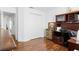 Bright bedroom featuring laminate floors, a workstation, and a spacious closet at 2325 W Del Webb Blvd, Sun City Center, FL 33573