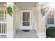 Close-up of the front door with decorative ironwork, surrounded by porch columns at 2325 W Del Webb Blvd, Sun City Center, FL 33573