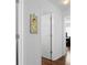 Hallway featuring hardwood floors and closet doors that provide ample storage at 2325 W Del Webb Blvd, Sun City Center, FL 33573
