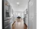 Modern kitchen with stainless steel appliances and white cabinets, leading to a dining area at 2325 W Del Webb Blvd, Sun City Center, FL 33573